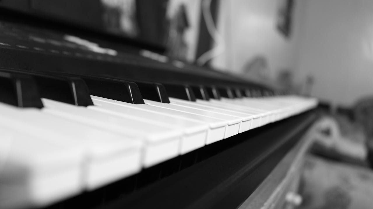 about-04 Classic black and white close-up of piano keys capturing the essence of musical harmony.